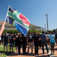 A protester waves a flag during a demonstration by South African farmers and farmworkers to protest against farmer murders in the country on Oct. 30, 2017, in Cape Town, South Africa.